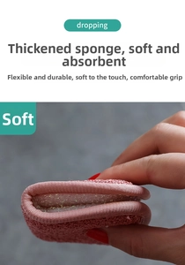 Detailed view of a pink dual-sided kitchen sponge showing high flexibility and soft texture