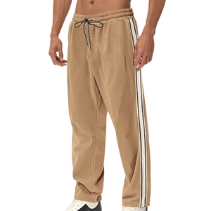 Detailed close-up of khaki corduroy pants showing elastic waist with drawstring and side stripes