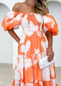 Detail of smocked bodice and layered floral tiered skirt on a summer maxi dress