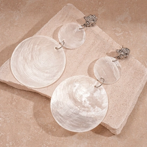 Exaggerated silver shell drop earrings with textured lion head and round mother of pearl