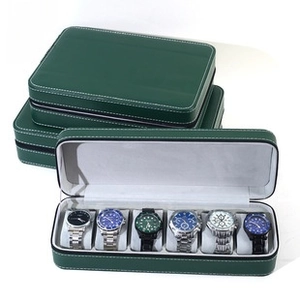Detail of dark green leather watch box with white stitching and secure zipper closure