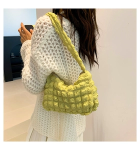 Detailed view of the bright yellow bubble texture fabric on this stylish pleated bag