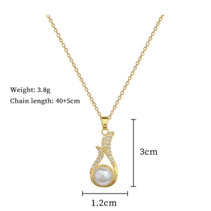 Macro detail of gold necklace with pearl drop pendant and sparkling diamond accents