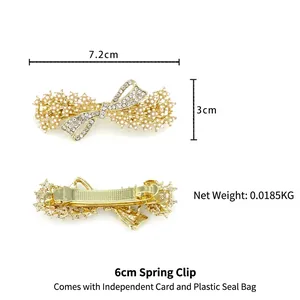 Elegant bow hair clip with white pearls and rhinestones on a gold alloy spring clip