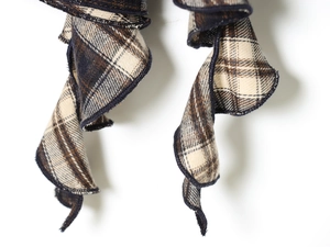 Detailed macro view of the classic blue and brown plaid fabric with stitched edges