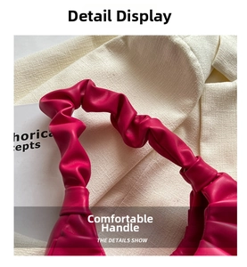 Close-up of vibrant pink pleated handle detail on a French style fashion shoulder bag