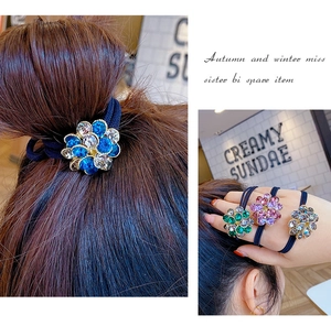 Macro detail of high-elasticity hair ties featuring crystal rhinestone flower motifs