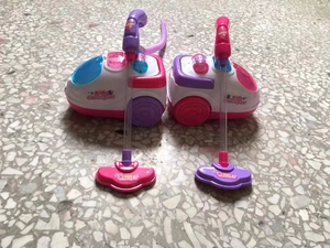 Detail of pink and purple kids toy vacuum cleaner sets with flexible hoses and floor heads