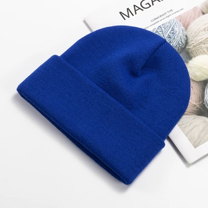 Detailed close-up showing the royal blue knitted texture and soft wool fabric of the beanie