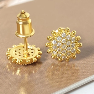 Golden sunburst flower stud earrings with sparkling cubic zirconia and butterfly backing