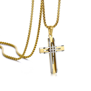 Close-up of gold and silver layered cross pendant with stylish golden box chain link
