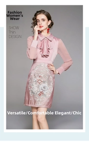 Detail of pink satin dress featuring floral embroidery and a bow collar detail