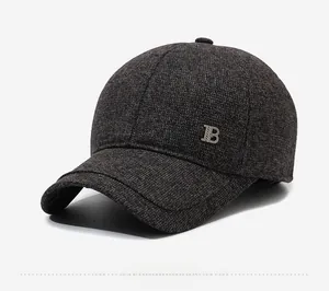 Detailed side view of a gray winter baseball cap with knit texture and silver metal B logo