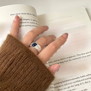 Close-up of S925 silver irregular ring with deep blue rectangle gemstone on a model hand