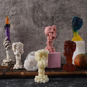 Detail of Halloween skeleton head with rose candle molds and finished wax crafts