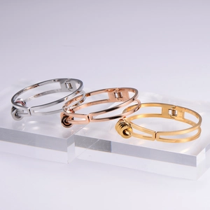 Polished titanium steel open bangles with rotating rings in gold, silver and rose gold