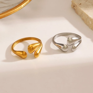 Minimalist gold and silver stainless steel water drop open rings on aesthetic background