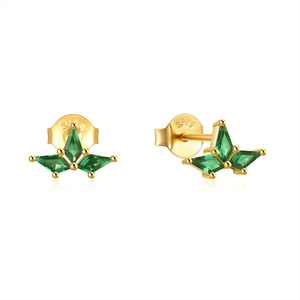 Macro shot of S925 sterling silver stamp on golden earrings with green marquise zircon