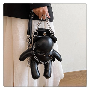 Detail of cute black PU leather bear bag with chunky silver metal chain handle and strap