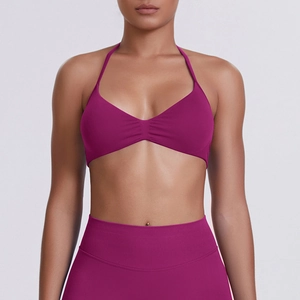 Close-up of seamless halter yoga top in rose red with subtle pleated chest detail