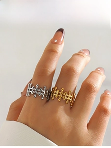 Detail of geometric stainless steel rings with minimalist bar and ball design