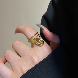 Detail of 18k gold plated stainless steel multi-layer ring with conch and star charms