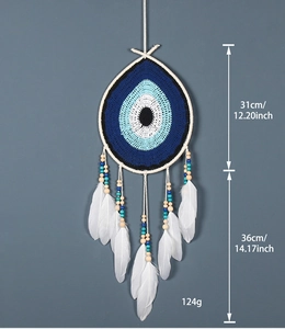Detail of blue evil eye dreamcatcher with white feathers and wooden beads showing dimensions