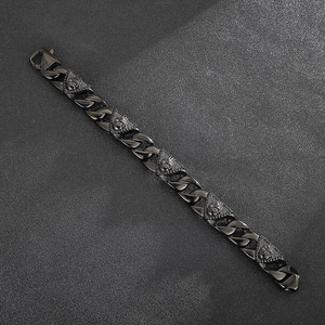 Close-up of black Cuban chain bracelet featuring detailed pharaoh skull charms
