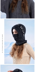 Close-up of a navy blue fleece-lined knitted balaclava with Warm embroidery text