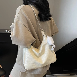 White faux crocodile skin woven shoulder bag with silver chain strap and plush charm