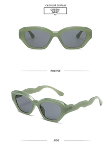 Detail view of green cat eye sunglasses with grey lenses and unique wavy temple design