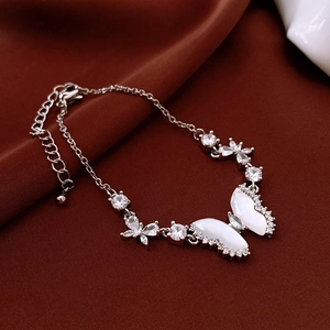 Detail view of silver butterfly bracelet with white shell inlay and sparkling zircon stones