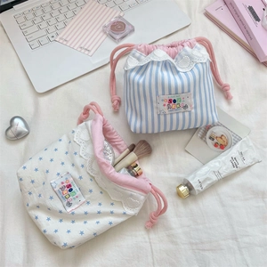 Close-up of cute lace-trimmed cotton drawstring bags for makeup and toiletry storage