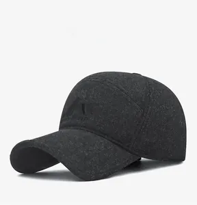 Close-up of dark grey winter baseball cap with embossed logo and textured fabric