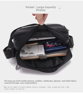 Macro view of multi-compartment interior storage of black crossbody shoulder bag