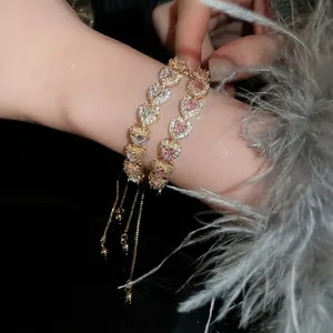 Elegant gold-plated chain bracelet with pink heart gemstone and pavé crystal heart charms