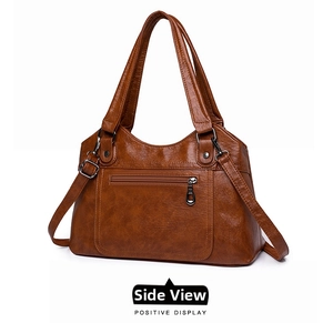 Vue détaillée à 45 degrés du sac cabas en cuir marron avec fermeture éclair et garnitures