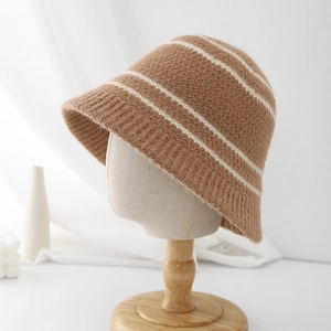 Close-up of brown knit bucket hat featuring soft wool texture and white stripe details