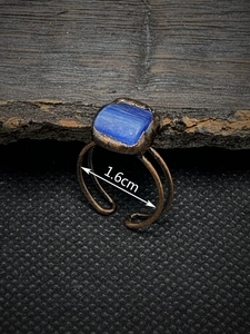 Macro shot showing 1.6cm inner diameter of vintage bronze ring with blue stone