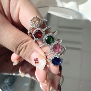 Close-up of five S925 sterling silver halo rings with colorful zircon round main stones