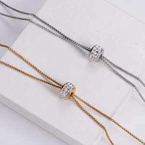 Minimalist gold and silver layered necklace with sparkling zircon cylinder pendants