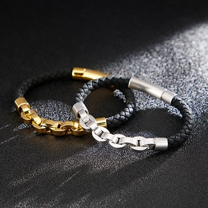 Detailed view of woven leather bracelets with polished gold and silver metal chain links