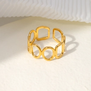 Macro detail of gold geometric hollow open ring with polished stainless steel finish