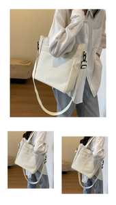 Detail showing the white tote bag adjustable strap and front pocket on model
