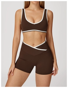 Close-up of contrast trim on cross high-waist yoga shorts and racerback sports bra
