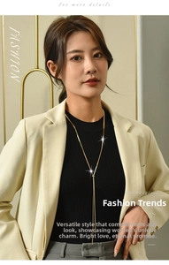 Detailed view of adjustable gold snake chain necklace with Y-shaped design and tassel