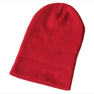 Detailed close-up of a vibrant red knitted beanie made of warm acrylic fibers on white