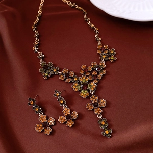 Detailed view of vintage flower jewelry set with colorful rhinestones on silk