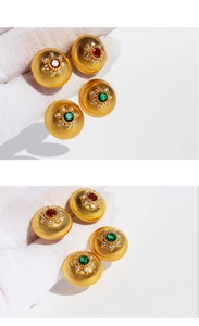 Detail of vintage dome earrings with gold spiral texture and center crystal clusters