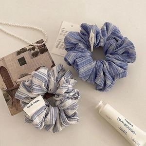 Set of two striped fabric scrunchies in blue and white with hand-made labels